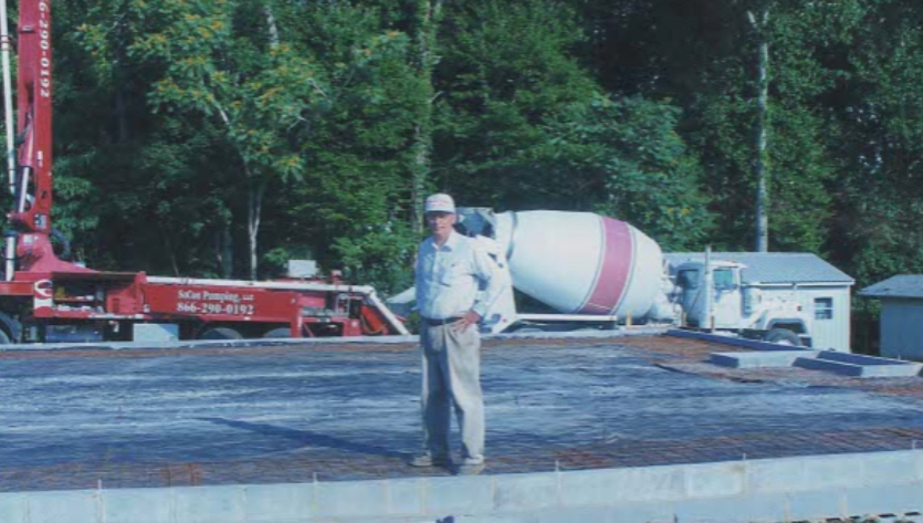 Pouring concrete. Bill Preskitt (Pastor) pictured.